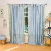 Gray sari tab top curtains hung at a window