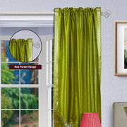 Olive green sari rod pocket curtains hung at a window