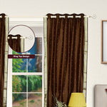 Brown sari grommet top curtains hung at a window
