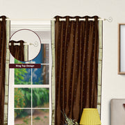 Brown sari grommet top curtains hung at a window