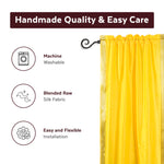 Yellow sari rod pocket curtains hung at a window