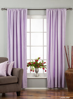 Lavender velvet rod pocket curtains hung at a window