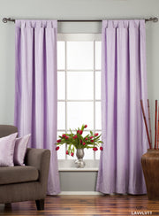 Lavender velvet tab top curtains hung at a window
