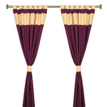 Maroon raw silk tab top curtains hung at a window