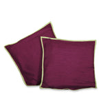 Maroon raw silk cushion covers arranged on a sofa