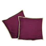 Maroon raw silk cushion covers arranged on a sofa