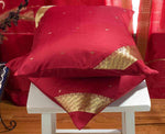 Maroon sari cushion covers arranged on a sofa