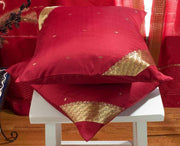 Maroon sari cushion covers arranged on a sofa