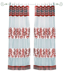 Maroon sheer tissue ring top curtains hung at a window