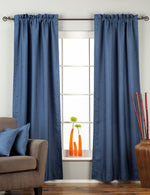 Blue raw silk rod pocket curtains hung at a window