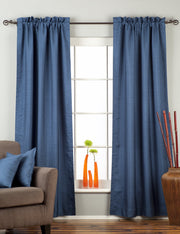 Blue raw silk rod pocket curtains hung at a window