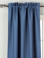 Blue raw silk rod pocket curtains hung at a window
