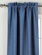 Blue raw silk rod pocket curtains hung at a window
