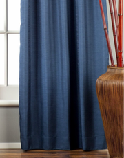 Blue raw silk ring top curtains hung at a window