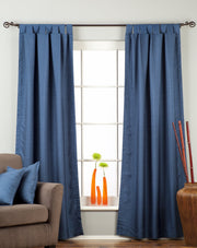 Blue raw silk tab top curtains hung at a window