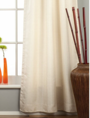 Cream raw silk tab top curtains hung at a window