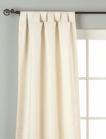 Cream raw silk tab top curtains hung at a window