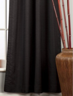 Black raw silk rod pocket curtains hung at a window