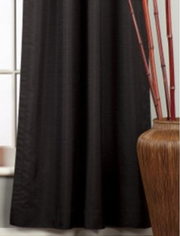Black raw silk rod pocket curtains hung at a window