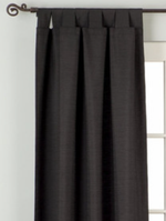Black raw silk tab top curtains hung at a window