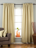 Olive green raw silk rod pocket curtains hung at a window