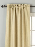 Olive green raw silk rod pocket curtains hung at a window