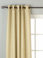Olive green raw silk grommet top curtains hung at a window