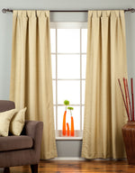 Olive green raw silk tab top curtains hung at a window