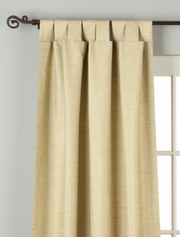 Olive green raw silk tab top curtains hung at a window