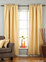 Golden rod raw silk rod pocket curtains hung at a window