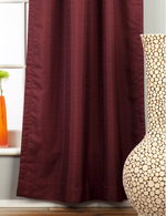 Maroon raw silk rod pocket curtains hung at a window