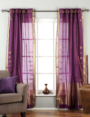 Purple sari ring top curtains hung at a window
