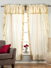 Cream sari rod pocket curtains hung at a window
