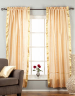 Misty rose sari rod pocket curtains hung at a window