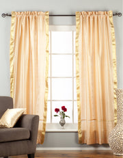 Misty rose sari rod pocket curtains hung at a window