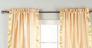 Misty rose sari rod pocket curtains hung at a window