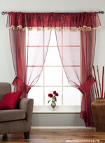 Maroon sheer tissue rod pocket curtains hung at a window