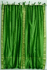 Forest green sari tie top curtains hung at a window