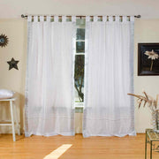 Silver sari tab top curtains hung at a window