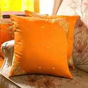 Earthy mustard sari cushion covers arranged on a sofa