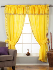 Cream sari rod pocket curtains hung at a window