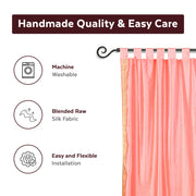 Pink sari tab top curtains hung at a window