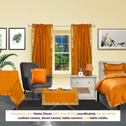 Mustard sari rod pocket curtains hung at a window
