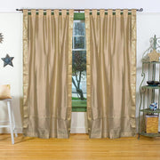 Golden sari tab top curtains hung at a window