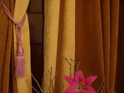 Peach sari curtain tiebacks holding a panel open