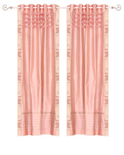 Peach sari grommet top curtains hung at a window