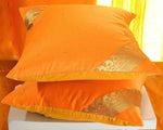 Pumpkin sari cushion covers arranged on a sofa