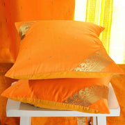 Pumpkin sari cushion covers arranged on a sofa