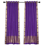 Purple sari ring top curtains hung at a window
