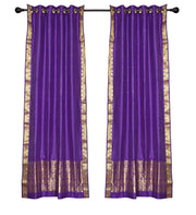 Purple sari ring top curtains hung at a window
